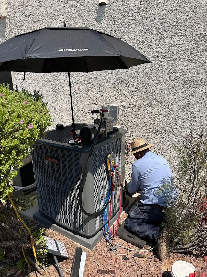 HVAC technician performing outdoor AC maintenance in Warrenton