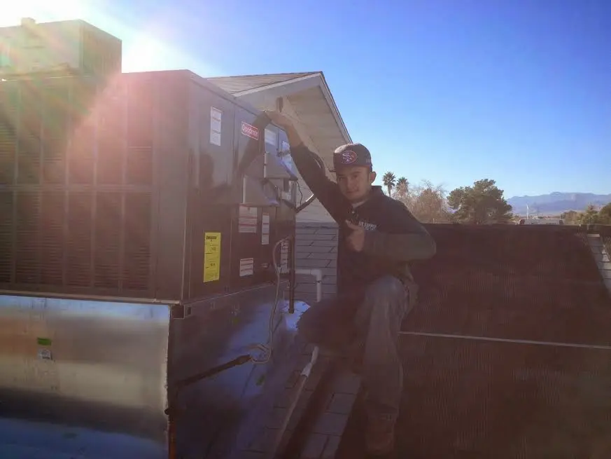 HVAC technician performing HVAC Inspection on a rooftop unit in Warrenton